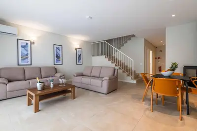 a living room with a couch and a table at DK Stays Residences Albufeira in Albufeira