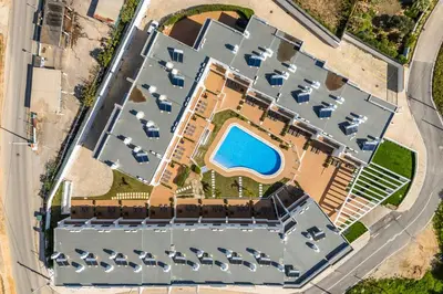 an overhead view of a large building with a pool at DK Stays Residences Albufeira in Albufeira