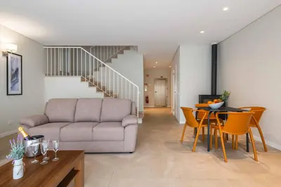a living room with a couch and a table at DK Stays Residences Albufeira in Albufeira