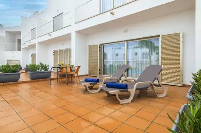 a patio with chairs and a table on a building at DK Stays Residences Albufeira in Albufeira