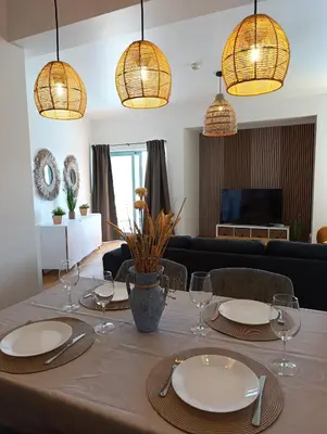 a dining room table with plates and wine glasses at Marina 3B 1B By AL in Albufeira