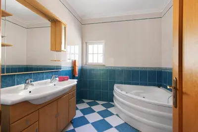 a bathroom with a tub and a sink at Solar das Andorinhas in Albufeira