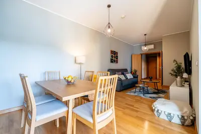 a dining room and living room with a table and chairs at Marina 4B 1D By RS in Albufeira