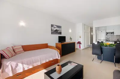 a living room with a couch and a table at Apartament Dita in Albufeira