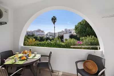 a room with a table and chairs and a window at Apartament Dita in Albufeira