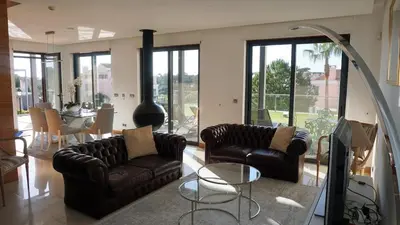 a living room with two leather couches and a table at Luxury 3 Bedroom, 3 ensuits, Private pool, Vale do Lobo in Loulé