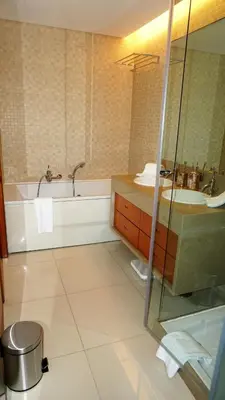 a bathroom with a tub and a sink at Luxury 3 Bedroom, 3 ensuits, Private pool, Vale do Lobo in Loulé