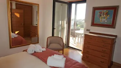 a bedroom with a large mirror and a bed with towels at Luxury 3 Bedroom, 3 ensuits, Private pool, Vale do Lobo in Loulé
