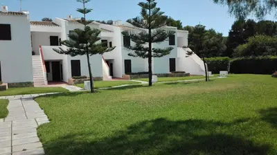 a large white house with trees in the yard at Apart. Barracuda in Vilamoura