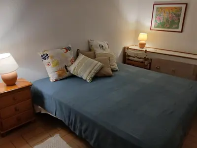 a bedroom with a bed with blue sheets and pillows at Apart. Barracuda in Vilamoura