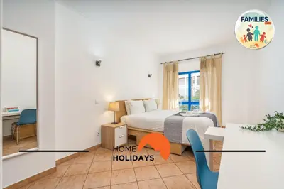 a bedroom with a bed and a room with a table at #290 Families Only - Choro Azul by Home Holidays in Albufeira