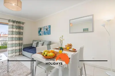 a kitchen and living room with a table with fruit on it at #284 Vista das Ondas by Home Holidays in Albufeira