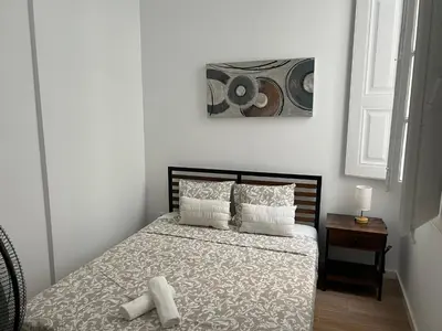 a bedroom with a bed with two candles on it at Yellow Guesthouse in Faro