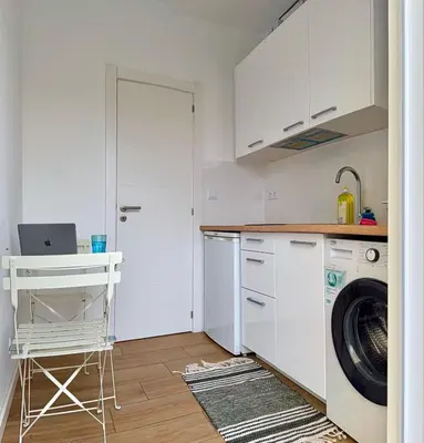 a bedroom with a bed and a table and a window at Yellow Guesthouse in Faro