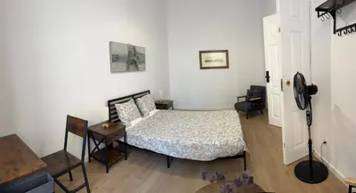 a bedroom with a bed and a table and a desk at Yellow Guesthouse in Faro