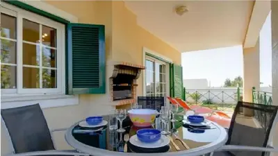 a dining room with a glass table and chairs at Vilamoura - Apartment near Mariana & Falesia Beach in Quarteira