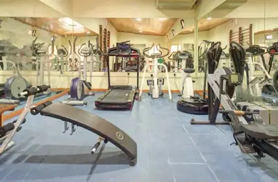a gym with several treadmills and machines at Casablanca - Dream Lodging in Albufeira