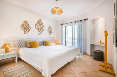 a living room with a couch and a table at Our House in Clube Albufeira in Albufeira