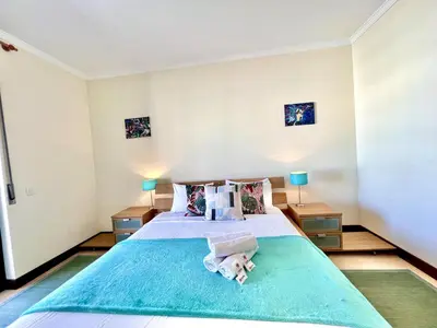a bedroom with a large bed with towels on it at Albufeira Salgados Beach 6 by Homing in Albufeira