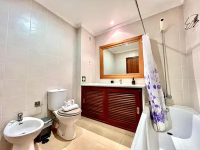a bathroom with a toilet sink and a mirror at Albufeira Salgados Beach 6 by Homing in Albufeira