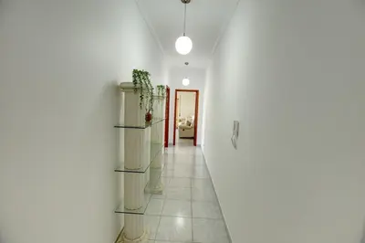 a hallway with white walls and a white floor at Quarteira Apartment with views in Quarteira