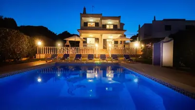 a swimming pool in front of a house at night at Casa do Algarve by Check-in Portugal in Albufeira