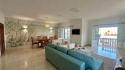 a living room with a blue couch and a table at Casa do Algarve by Check-in Portugal in Albufeira