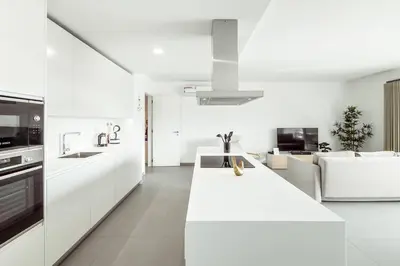 a white kitchen with a white counter top in a room at Albufeira Green Dream Pool, Balcony & BBQ in Albufeira