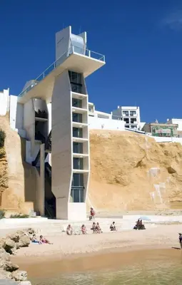 a building on the beach with people on the sand at Al Mare Ocean View in Albufeira