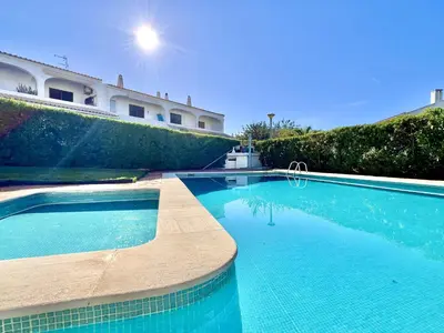 a swimming pool in front of a building at Vilamoura Classic 2 with Pool by Homing in Quarteira