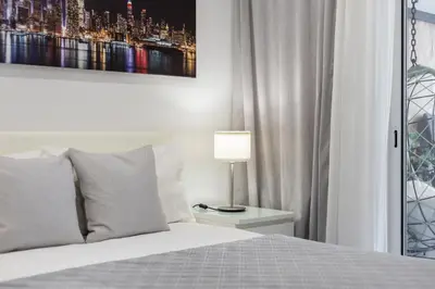 a bedroom with a bed and a lamp on a night stand at Casa dos Avós - Faro Relax & Comfort in Faro
