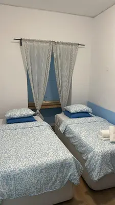 a bedroom with two beds and a window at Sweet Dreams in Albufeira