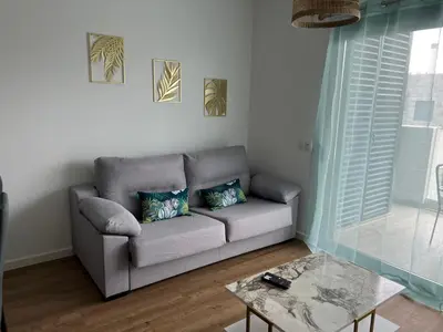 a living room with a couch and a table at Appartement T1 Faro in Faro