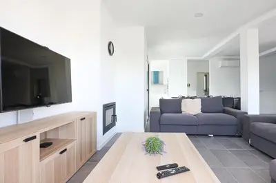 a living room with a couch and a tv at Villa Soares - Centro Albufeira - For Families - BY BEDZY in Albufeira