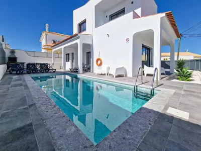 a swimming pool in front of a white house at Villa Soares - Centro Albufeira - For Families - BY BEDZY in Albufeira