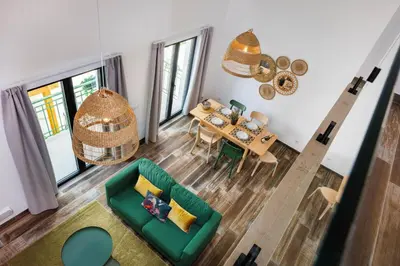 an overhead view of a living room with a green couch at Roots Apartments in Faro