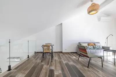 a living room with a couch and a table at Roots Apartments in Faro