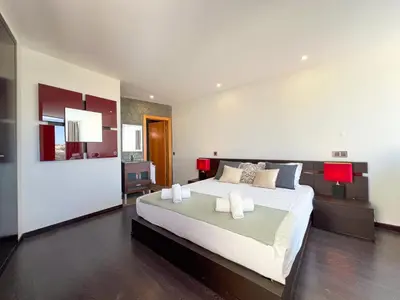 a bedroom with a large bed in a room at Luxury 4-Suite Villa, Pool, Jacuzzi, Games Room in Albufeira