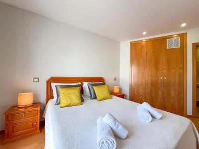 a bedroom with a large bed with towels on it at Luxury 4-Suite Villa, Pool, Jacuzzi, Games Room in Albufeira