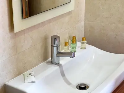 a sink with a faucet and two bottles on it at Luxury 4-Suite Villa, Pool, Jacuzzi, Games Room in Albufeira