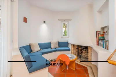 a living room with a blue couch and a fireplace at #250 Apartamento 264 by Home Holidays in Albufeira