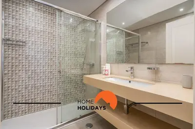 a bathroom with a shower and a sink with a mirror at #250 Apartamento 264 by Home Holidays in Albufeira