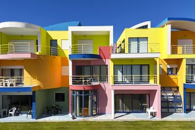 a building with colorful balconies on the side of it at Marina Orada Apartment with Pool - 900m from the Beach in Albufeira