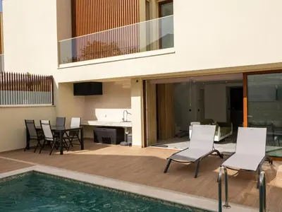 a house with a swimming pool next to a house at Eco Residence 05 House by Stay ici Algarve Holiday Rental in Albufeira
