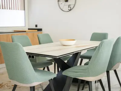 a conference room with a table and green chairs at Eco Residence 05 House by Stay ici Algarve Holiday Rental in Albufeira