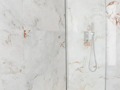 a shower in a bathroom with white marble at Eco Residence 05 House by Stay ici Algarve Holiday Rental in Albufeira