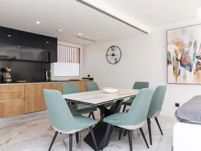 a kitchen and dining room with a table and chairs at Eco Residence 05 House by Stay ici Algarve Holiday Rental in Albufeira