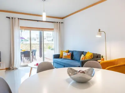 a living room with a table and a couch at Sunshine House by Stay ici Algarve Holiday Rental in Albufeira