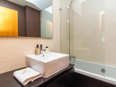 a bathroom with a sink and a shower at Sunshine House by Stay ici Algarve Holiday Rental in Albufeira