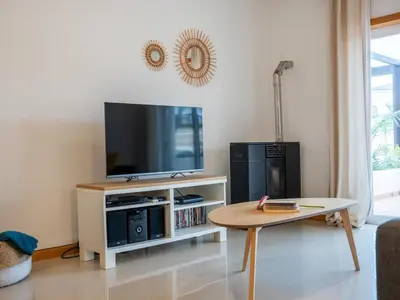 a living room with a tv and a coffee table at Sunshine House by Stay ici Algarve Holiday Rental in Albufeira